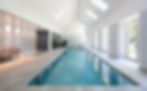 Indoor pool room with rooflights and tall glazed doors